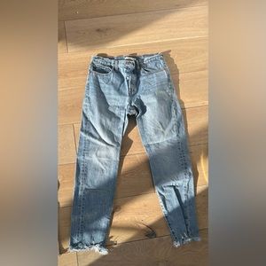 Cropped frayed light wash Levi jeans.